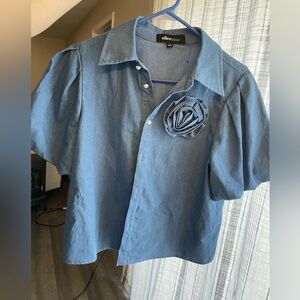 Blue denim-like puff sleeve top with flower detail and Pearl-like buttons